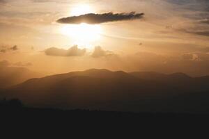 Sunset landscape with scenic mountains view photo