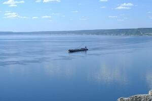 A cargo ship is sailing on the river Volga photo