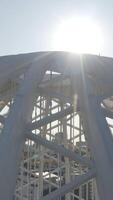 Modern domed structure with white beams. Stock footage. Domed building on sunny day. Modern architecture of domed white building video