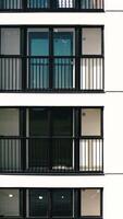 Top view of windows and balconies of modern house. Stock footage. Beautiful exterior of residential building with modern windows. Modern residential building with new windows and stylish balconies video
