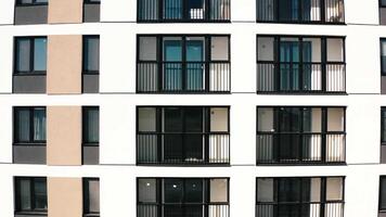 Top view of windows and balconies of modern house. Stock footage. Beautiful exterior of residential building with modern windows. Modern residential building with new windows and stylish balconies video