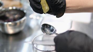 squeeze lemon juice into a spoon A chef squeezes lemon juice into a spoon. Making a Chicken and Egg Galette series. video
