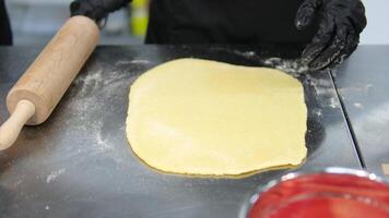 roll out the dough Pastry chef rolls out yeast dough using a rolling pin video