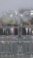 many empty glasses on black background with lights. glasses goblets. empty glasses and goblets video