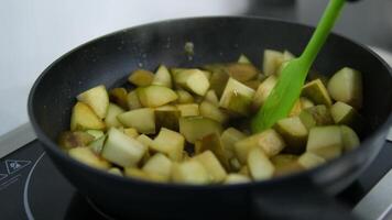 pear in a frying pan Preparing homemade caramelized pear on frying pan. Stirring pear on frying pan. video