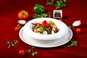 fattoush Salad include tomato, capsicum, beetroot, green herbs served in bowl isolated on red background side view of arabic food photo