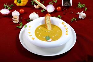 Lentil Soup with Bread served in bowl isolated on red background side view of arabic food photo