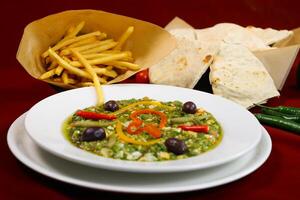 kafteji plate Tunisian Salad with French Fries and Pita Bread served in plate isolated on red background closeup side view of arabic food photo