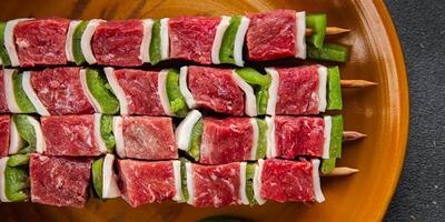 raw kebab meat and vegetables pork, lard, pepper, vegetable dish fresh delicious gourmet food background on the table rustic food top view copy space photo