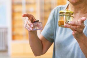 An educator demonstrates specimen preservation techniques with jars and containers during a biology workshop at a science center photo