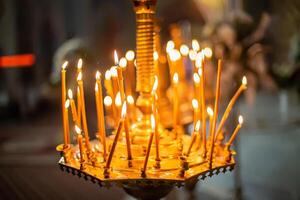 Smoke from the extinct candles. Chandelier with candles in the Church. Background for photobooks about baptism. photo