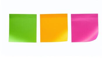 Three different colored sticky notes on a white surface photo