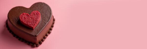 Heart-shaped chocolate mousse cake for Valentine's Day on a pink monotone background. Banner with copy space. photo
