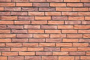 a new House is being built, the beginning of brickwork with red bricks, building materials, a pattern of stones, a natural background. High quality photo