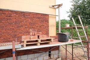 building a house supporting structure for laying bricks around a wooden base, a new House is being built, building materials, High quality photo