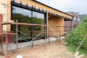 building a house supporting structure for laying bricks around a wooden base, a new House is being built, building materials, High quality photo