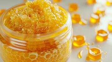 luxurious honey body scrub in a container on a white background with honeycomb accents, ideal for exfoliation and skin rejuvenation photo