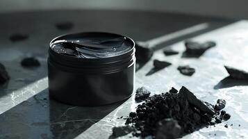 activated charcoal facial moisturizer container with charcoal pieces on wooden table photo