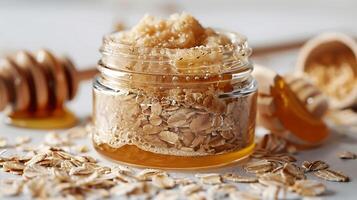 oatmeal face scrub in a jar with oats and honey on white background for smooth skin. photo