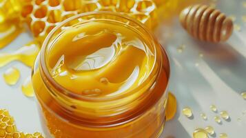 organic honey face lotion in a jar displayed on a clean white surface with honeycomb pattern, ideal for skincare routine. photo