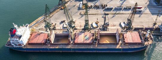 Panoramic view from a drone of a large ship loading grain for export. Water transport photo