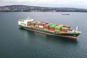 Aerial view of a container cargo ship on the sea. Cargo and shipping logistics businessAerial view of a container cargo ship on the sea. Cargo and shipping logistics business photo