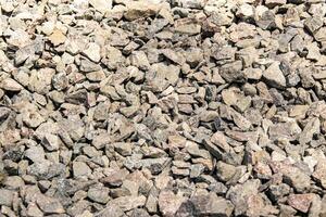 A close-up view of small, grey rocks on a sunny day photo