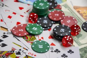 A close-up shot of a table scattered with poker chips, playing cards, and dice photo
