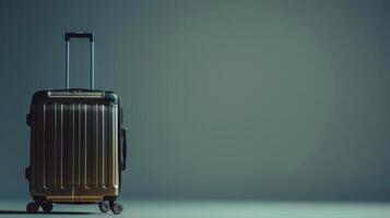 A stylish suitcase with a modern design waits quietly on a smooth floor, illuminated by soft lighting that highlights its sleek surface and prepared for upcoming journeys photo