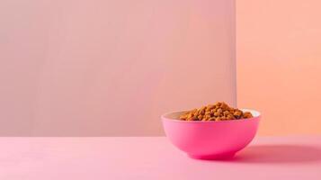 A bright pink bowl filled with cat food rests on a plain white surface, contrasted by a soft pastel background. The food is visually enticing and ready for feeding photo