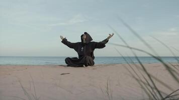 Monk Asks For Help From The Most High Almighty Sitting On The Beach In Prayer photo