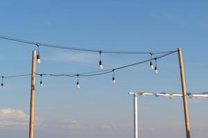 Light bulbs on a bright and slightly cloudy blue sky background photo