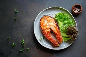 fresh salmon fried fish in a plate grilled seafood omega ready to eat on the table for healthy meal snack outdoor top view copy space food background rustic image pescetarian diet photo
