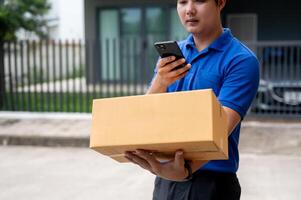 A delivery guy is taking a picture of a package before delivering it in front of a customer's house. photo