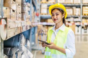 Portrait of asian woman warehouse worker in uniform checks stock and inventory with digital tablet computer, working in delivery, distribution center, logistic and business export photo