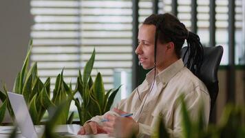 Ethnic hipster Hispanic business man Latina male student studying distant e-learning American guy worker manager working laptop call talking conference interview online in office writing notes video