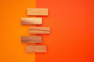 Top view of five empty wooden blocks isolated on an orange and red background photo