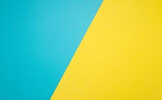 Top view of blue and yellow paper background with space for text photo