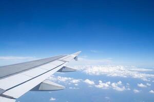 Aerial view of clouds and sky as seen through the window of an aircraft photo