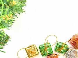 Part of Christmas tree and colorful gift boxes isolated on white background. Space for text. Top view. Flat lay. Christmas and Happy New Year concept photo