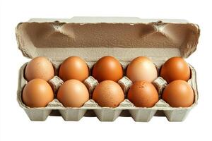 An open egg box containing ten brown eggs is isolated on a white background, emphasizing fresh organic chicken eggs stored in a carton pack with ample copy space provided. photo