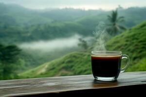 a hot black coffee on wooden table in the morning with mountain and nature background photo