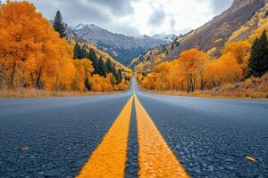 asphalt road with yellow lines. Highway with mountains and autumn trees. Road travel concept. photo
