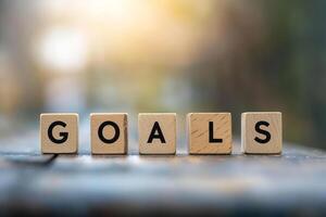 goals text on wooden cubes. Business development strategy, advancement and goal concept. photo