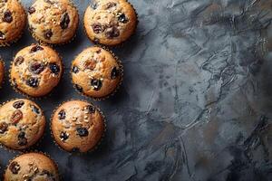 Delicious Muffins with Raisins on Rustic Gray Background - Ideal for Baking, Recipe Design, and Food Blog Graphics photo