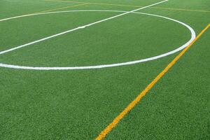 Detail of the center of an artificial grass 7-a-side football field. photo