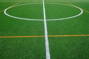 detail of the surface of an artificial grass soccer field photo