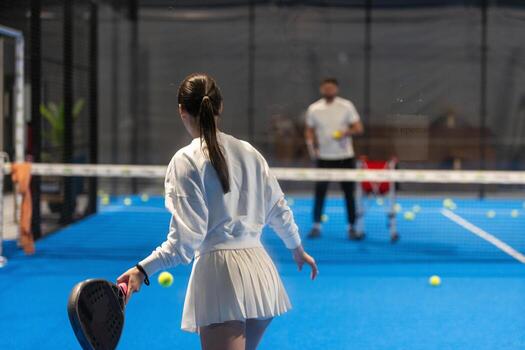 Young Girls Is Playing Padel on an Court. photo