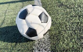 top view of football on green field , soccer ball on grass photo