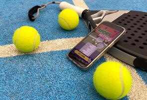 padel tennis and sports betting on a smartphone. Concept of sports bet photo